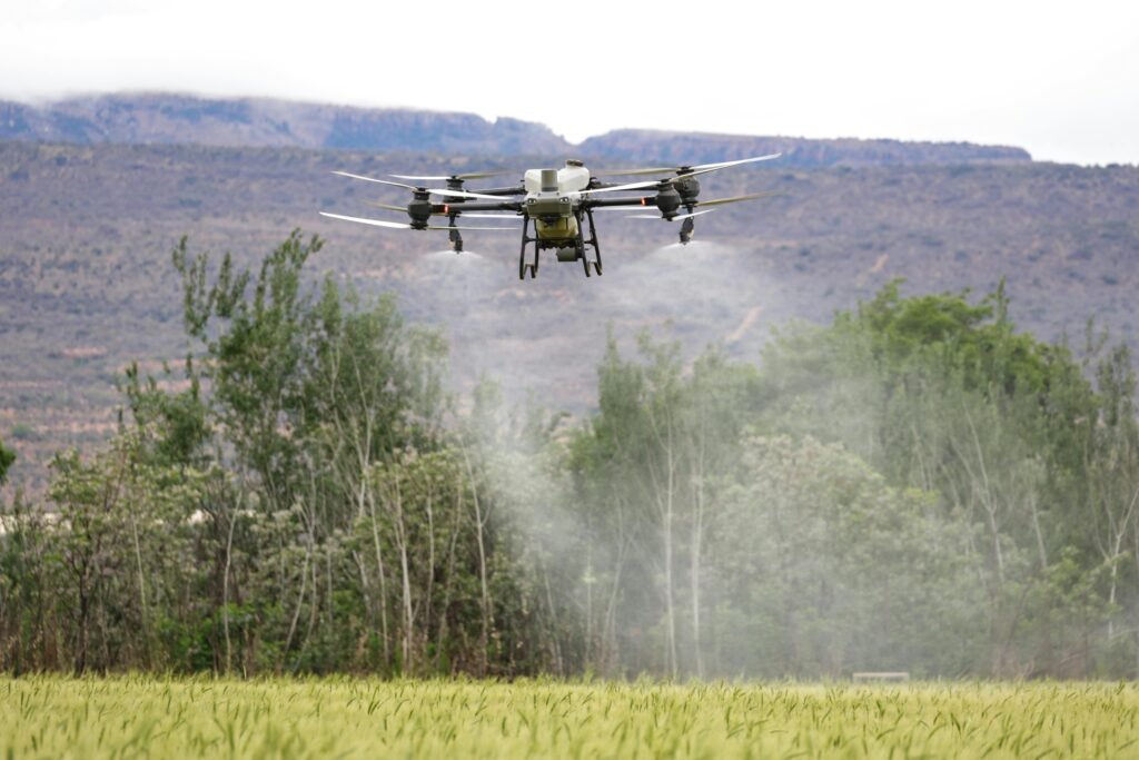 A drone spraying water or a solar-powered irrigation system.