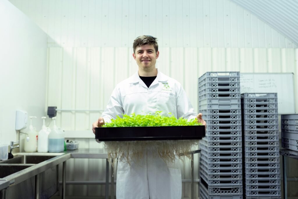 Scientist carefully holding freshly harvested crops during examination in a modern agricultural research laboratory, highlighting the ongoing USDA staffing crisis and its impact on agricultural research.